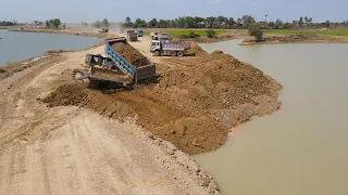 Nice Team Work Dump Truck Moving Soil and Bulldozer KOMATSU D60P Push Soil Drop Down Deep Water