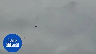 UFOs over England? Five mysterious donut-shaped objects filmed hovering in the sky