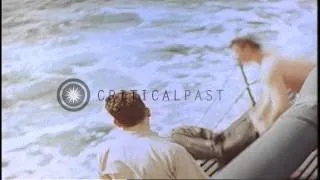 Crew members aboard USS Springer recover a dead Japanese pilot in the Pacific Oce...HD Stock Footage