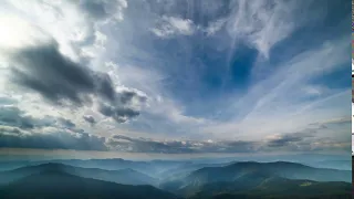 the picturesque mountain landscape on the cloud flow background time lapse