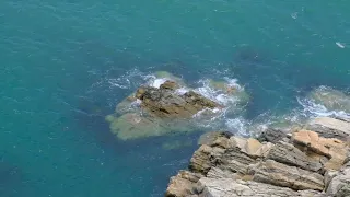 Calm gentle waves splashing on the rock