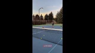 Boy falls over tennis ball basket