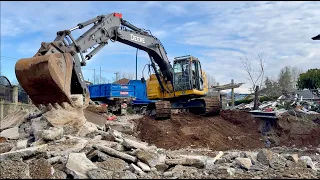 Excavator Removing Concrete and Loading Trucks