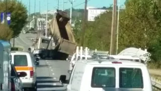 Dumb dump truck driver hung on power lines