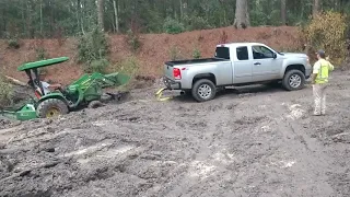 Duramax lml pulling tractor out the mud