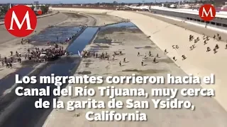 Migrantes intentan cruzar muro fronterizo