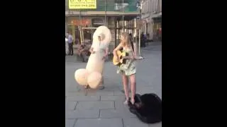 Inflatable willy dancing to busker in Bath