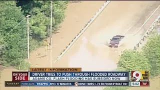 driver in flooded road