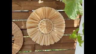 Wicker wall baskets with raffia and wooden deads. Boho decor.