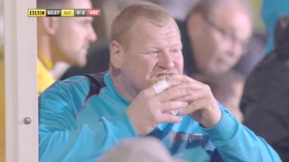 Wayne Shaw (Sutton United) taunts Arsenal with a pie