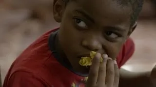 Bourdain learns how to eat Senegal's national dish