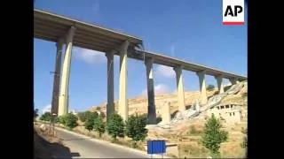 Nasrallah posters; suspension bridge damaged, civilians fleeing