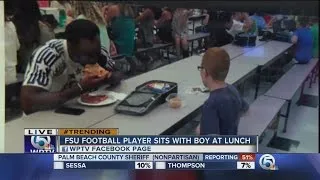 Florida State's Travis Rudolph eats lunch with boy with autism