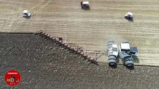 Big Bud 525/50 Tractor pulling an 18 Bottom Plow.