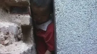 Chinese child trapped between two walls... Again!