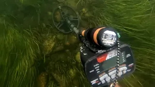 Unearthing Treasures: Exploring A Crystal Clear Riverbed With Metal Detectors