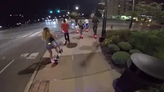 Electric Skateboard vs group of 10 Bird Scooters night race LED glow board across downtown bridge