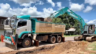 Kobelco Sk200-10 Digging out the ground to expand the roadway.