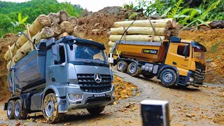 Controlled dump truck,RC truck transports full of wood on the vehicle through the mountain pass road