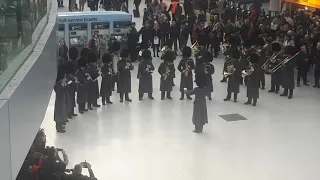 The  Band of the Genadier Guards perform "Our House" by Madness at London Waterloo Station.