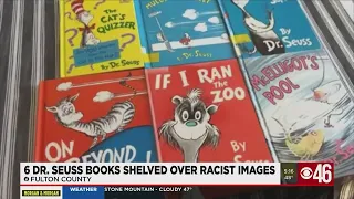 6 Dr. Seuss books shelved over racist images