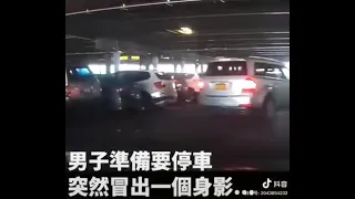 A Chinese lady standing on the parking.