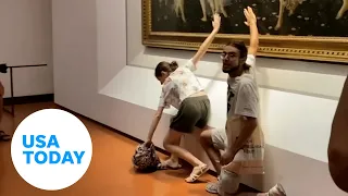 Protesters glue themselves to Botticelli artwork in Florence, Italy | USA TODAY
