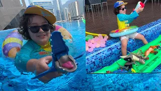 Emin saves his dinosaur toys from sinking | Playtime by the pool