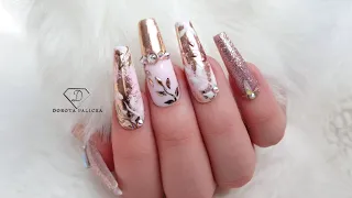 Rose gold and nude nails with transfer foil and chrome pigment.