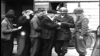 Soldiers check identification papers of civilians and weed out German soldiers we...HD Stock Footage