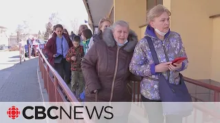 Refugees flock to Polish border after Russian airstrikes hit Lviv