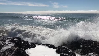 Slow motion waves crashing on rocks