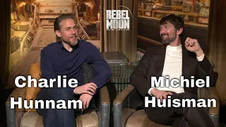 Charlie Hunnam & Michael Huisman discuss Rebel Moon, its crazy sets & creatures. Spoiler at End