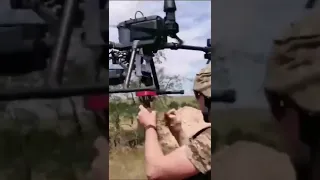 Ukrainian soldier arming a quadcopter drone with a 82 mm mortar round