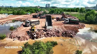 Smooth Process: Bulldozer Expertly Pushing Rock, Truck Efficiently Dumping Stone into Water