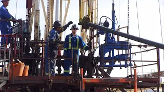 Independent Well Servicing pulling tubing in summer at Oungre, Saskatchewan