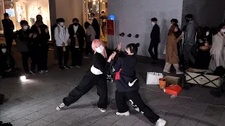 ONLOOKERS ENJOYING IMPROMPTU HAPPY BUSKING ON HONGDAE STREET. ONLOOKER CAN OFTEN DANCE AS GUEST.