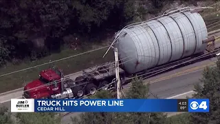 Oversized truck hits power lines, knocks out power