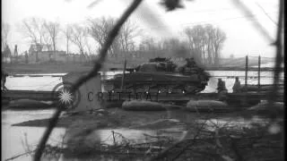 Soldiers aboard tanks cross a pontoon bridge across the Roer River in Julich, Ger...HD Stock Footage