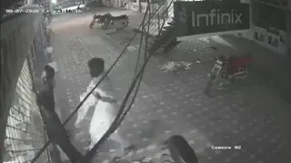 Jhelum young man was electrocuted by the shutters of a shop and a fellow friend saved him | CCTV |