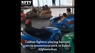 Taliban fighters playing bumper cars in an amusement park in Kabul