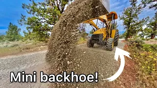 Spreading rock with a miniature backhoe  (and a bunch of other stuff too!)