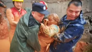 Firefighters Rescue Woman Buried by Landslide in China