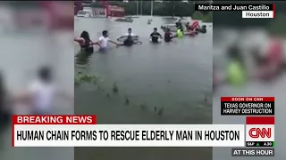 Group Of People Form A Human Chain To Rescue An Elderly Man From Flood Waters