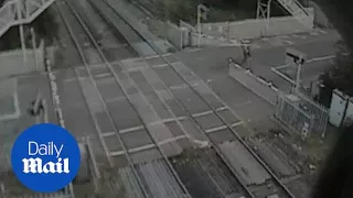 BMX rider is knocked to floor by lowering level crossing gate - Daily Mail