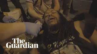 African American film-maker is pepper-sprayed then engages protest police in conversation