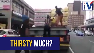 WATCH: Looters help themselves to drinks from moving truck