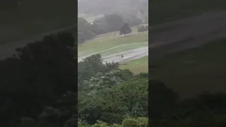 A person is seen surfing on a flooded road near Durban in KwaZulu Natal. Many roads become rivers