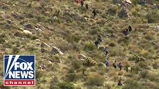 Migrants scale mountain like 'trail' of ants to get into US