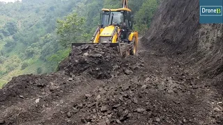 Clearing Hilly Road Dirt after Excavator-Backhoe Loader Working